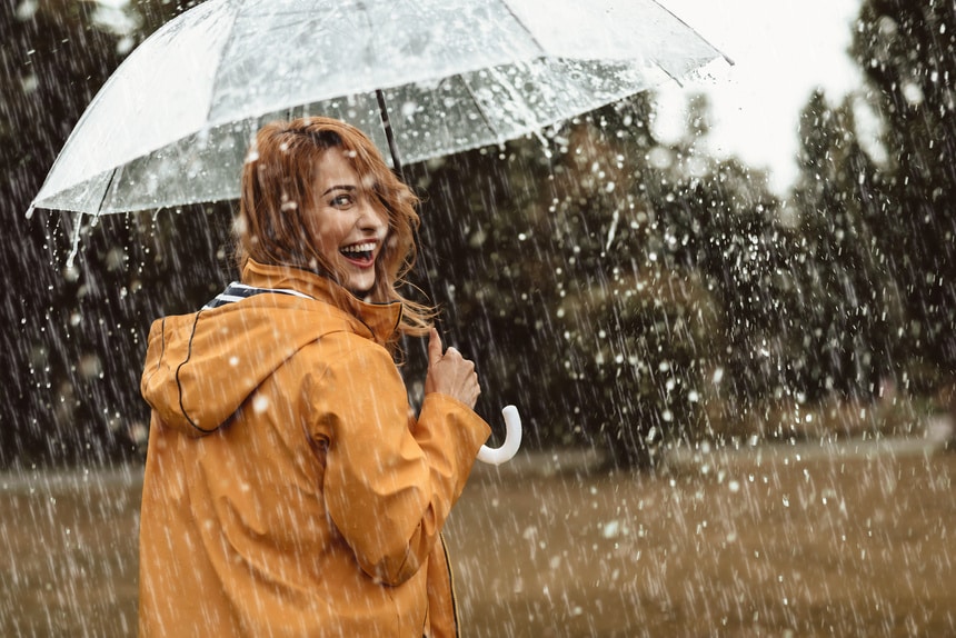 Woman outside holding an umbrella in the rain