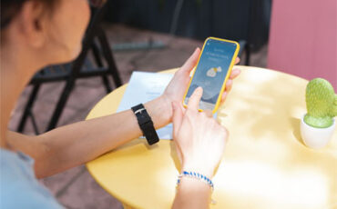 A woman checking the forecast on a weather app