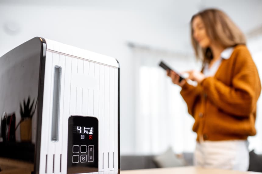 A woman controlling a smart humidifier in her home